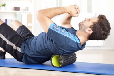 man lying on a foam roller while doing an exercise royalty free image 509421384 1545148853
